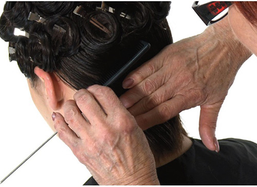Varying the direction of the curls helps to add dimension to a vintage curls hairstyle.
