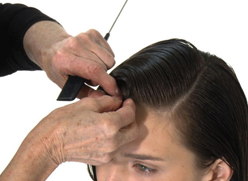 Place a classic finger wave into a pin curl to achieve a dramatic deep side parting