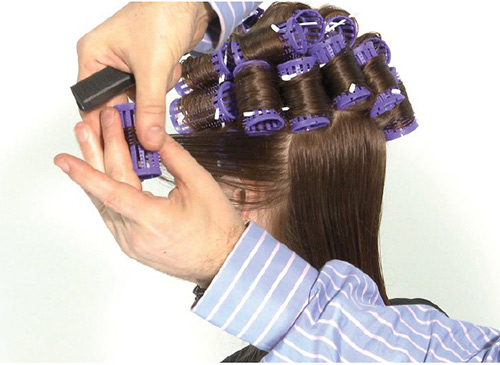 Hollywood curls are enhanced by applying rollers vertically for a dropped curl look.