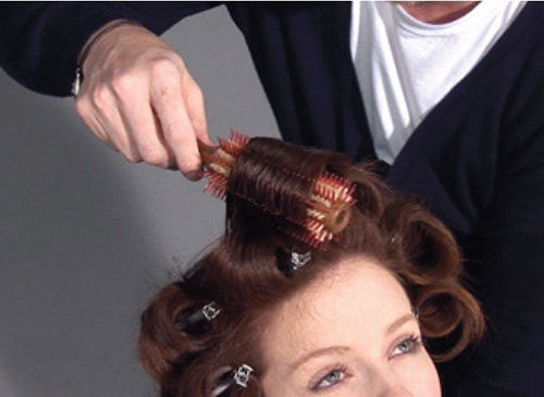 Blow dry the hair in sections the width and depth of your round brush. Secure each section and allow to cool.